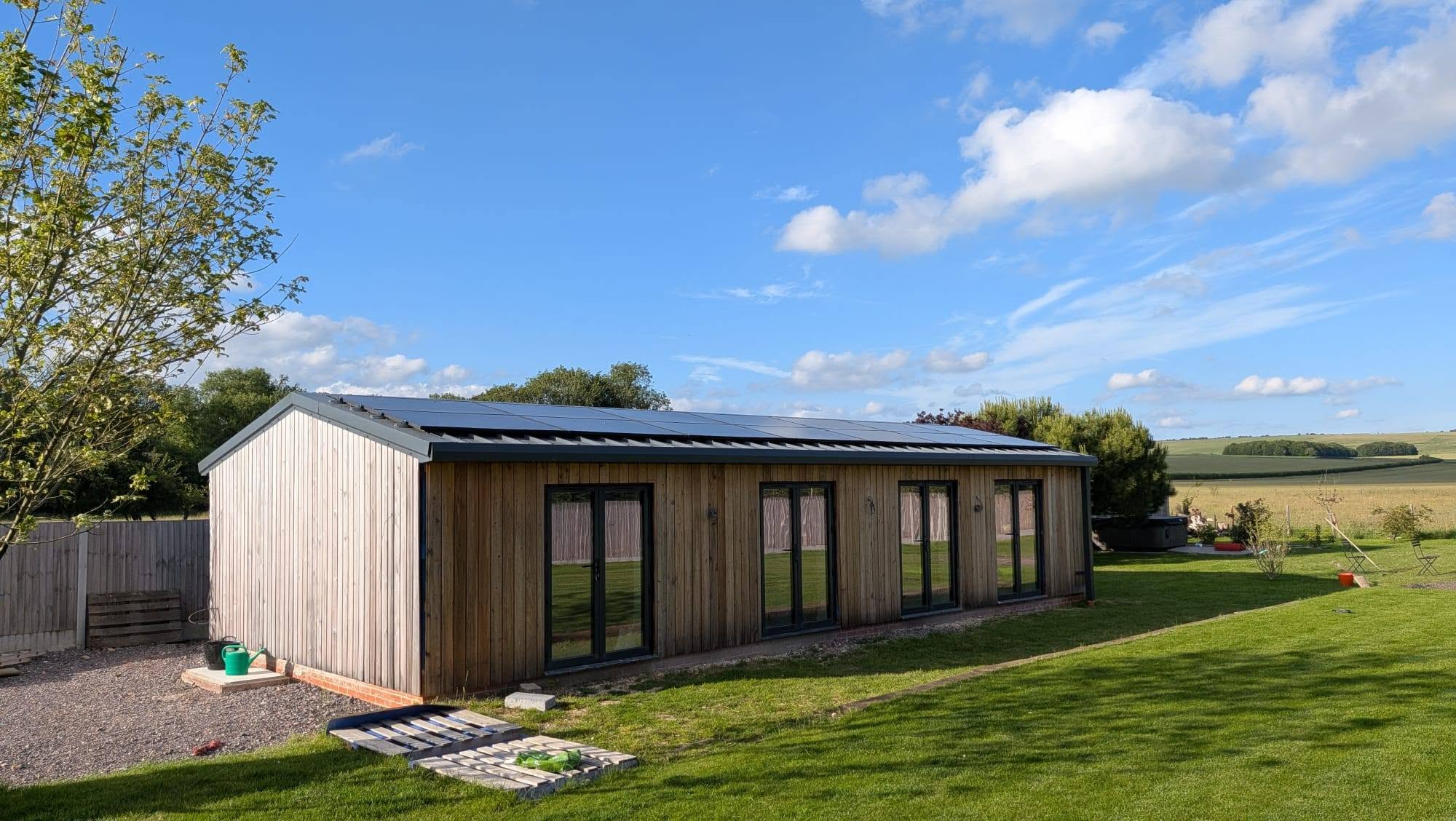 Solar panels installed across the roof of a contemporary timber home in Avebury.