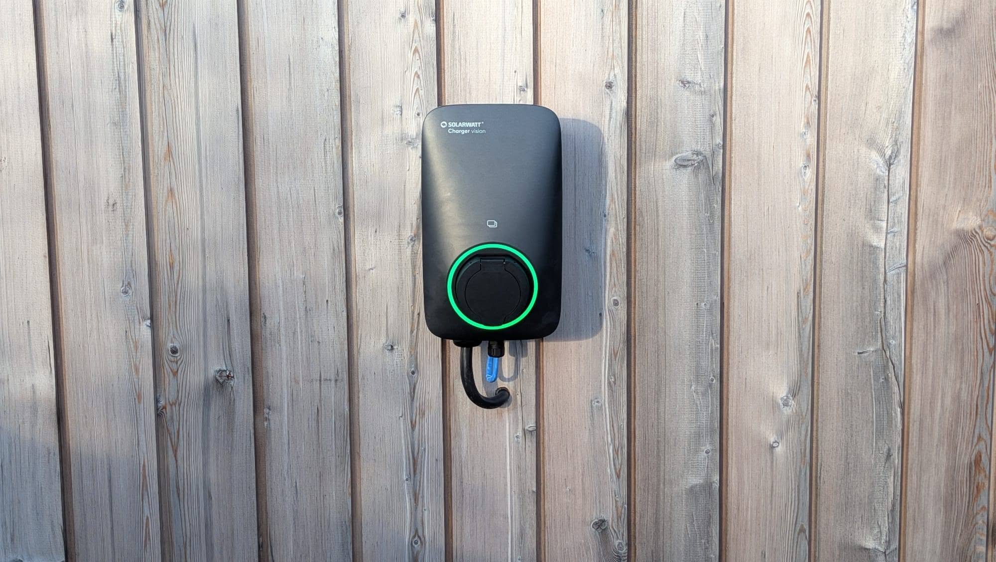A home electric vehicle charger installed on an exterior wall.