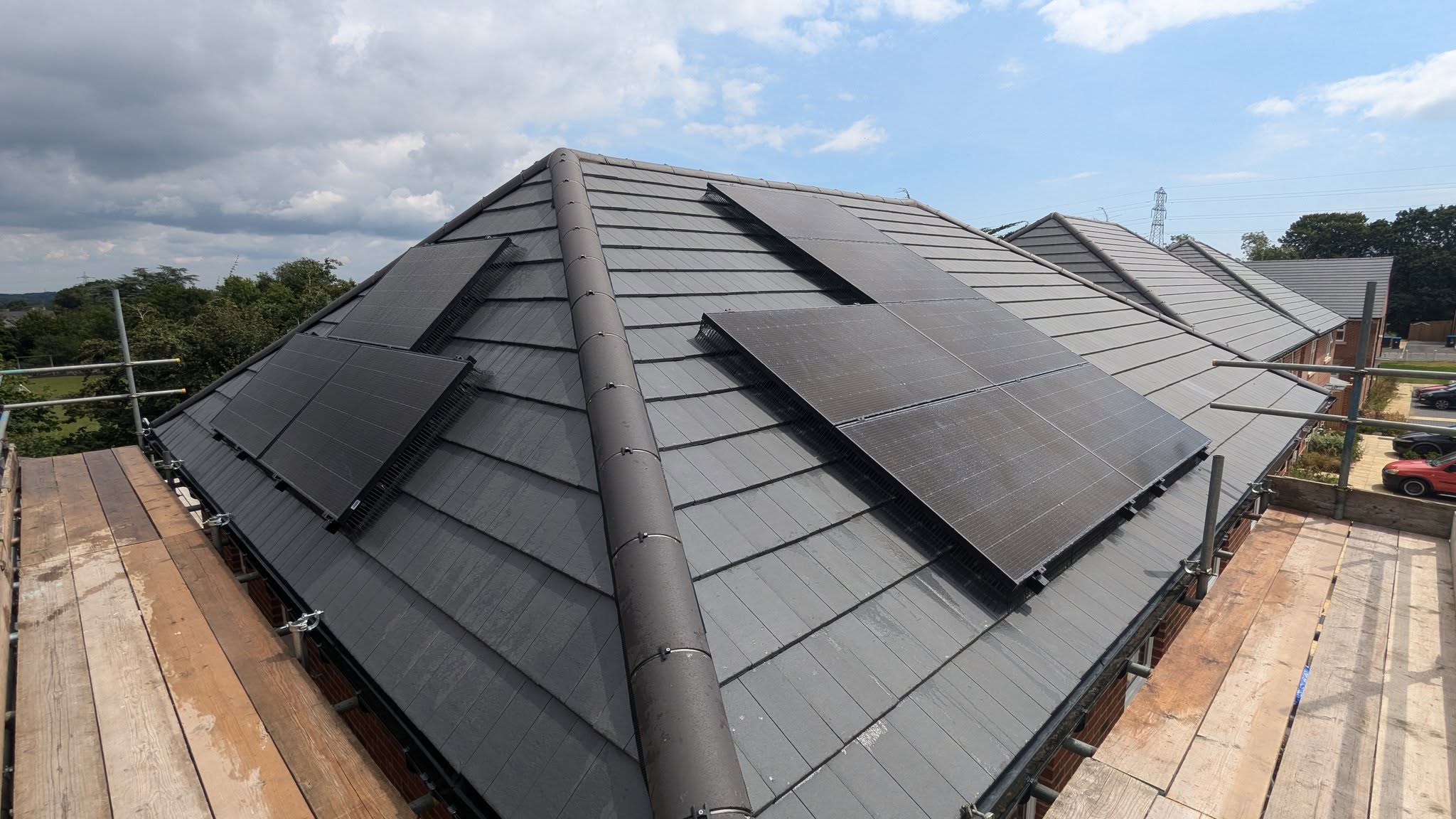 Solar panels installed across a broad grey tiled roof.